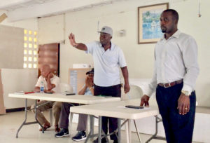 From left, board member John Jno-Pierre, vice-president Conrad Grant, president Fitzroy Harry and Sen. Marvin Blyden try to maintain order at the community meeting.