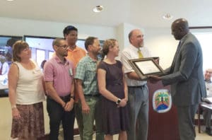 UVI President David Hall presents the Presidential Appreciation Award to UVI’s Center for Marine and Environmental Sciences. Receiving the award were, from right, Paul Jobsis, acting director of CMES; Marilyn Brandt, director of the master’s in marine and environmental sciences program; Stephen Prosterman, diving and marine field officer; Sennai Habtes, research assistant professor; and Howard Forbes Jr., director of the V.I. Marine and Advisory Service on St. Thomas; and Sandra Romano, dean of College of Science and Mathematics. (April Knight photo)