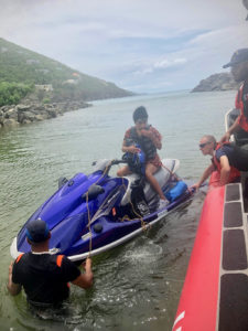 The boat crew of a Coast Guard SPC-LE stationed on St. Thomas take a pair of stranded boaters aboard off Hans Lollik Island.