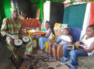 Junie Bomba teaches percussion to children in Frederiksted.