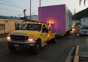 One of the modular classroom units is driven through St. Thomas to its new home at a V.I. public school. (Department of Education photo)