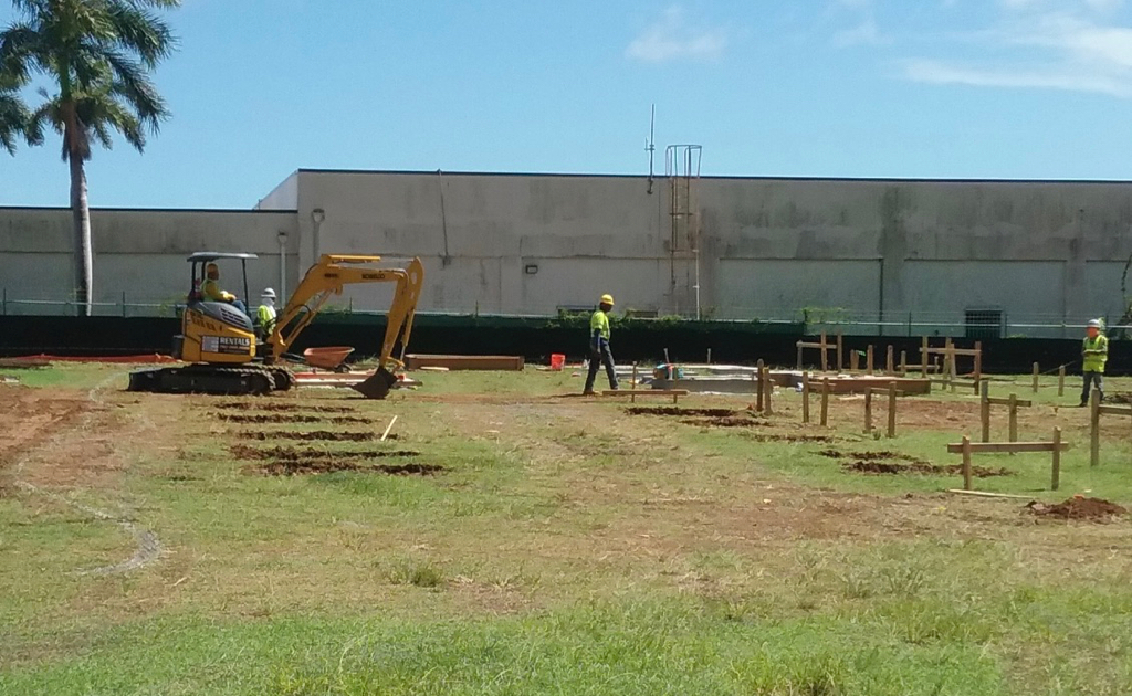 Workmen mark off space for installation of soon-to-arrive modular classrooms Thursday on campus at Lockhart Elementary School.