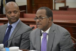 Budget Director Julio Rhymer addresses the Senate Finance Committee on Tuesday as Finance Commissioner Valdamier Collens listens. (Photo by Barry Leerdam, V.I. Legislature)