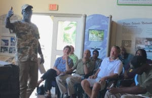 Irvin Mason explains what to pack in a hurricane kit while LTRT board members listen.