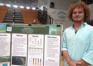 Matthew Mullins studies an invasive species of algae and how it affects the diversity of local fish. (Gerard Sperry photo)