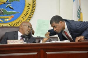 Senate President Myron Jackson and Sen. Kurt Vialet confer during Friday's session. (Photo by Barry Leerdam, V.I. Legislature)