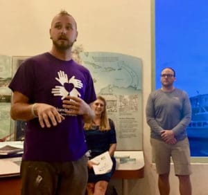 Jon Griswold of All Hands and Hearts describes new construction programs while Celia Kalousek and Devin Murphy listen.