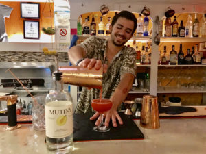 Carson Delledonne mixes up a cocktail with Mutiny Island Vodka behind the bar at 40 Stand Eatery.