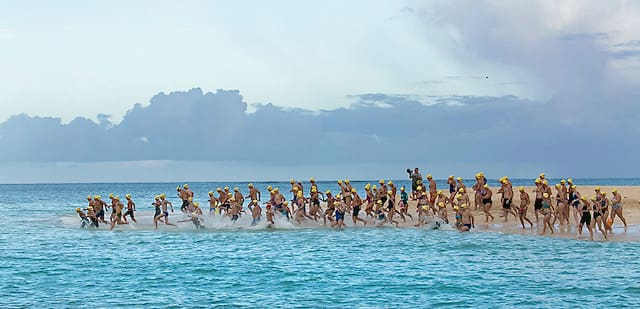 Swimmers at Buck Island hit the water for the start of the 23rd Annual Coral Reef Swim. (Image by Steve Simonsen Photography)
