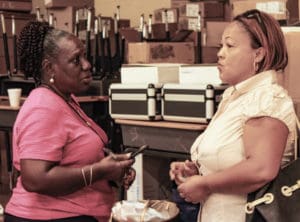 Polling judge Jacqueline Callwood, left, answers a voter’s questions. (April Knight photo)