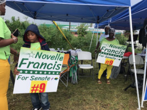 Supporters of Novelle Francis campaign for their candidate outside Juanita Gardine School.