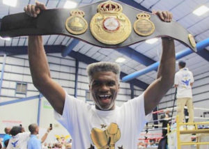 In this 2017 photo, three-time world boxing champion Julian 'The Hawk' Jackson of the USVI holds aloft a replica of his first world-title belt he had just been presented. 