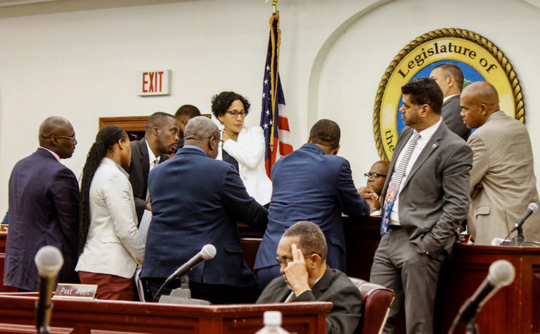 Lawmakers huddle in a rush to tackle various bills during their last session.