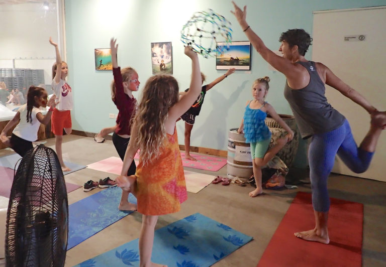 Yoga instructor Shera Evens and her young class practice the dancer pose. (Susan Ellis photo)
