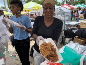 Roti Master Diane Noel shows off the good color in her Chicken Pelau at the 2019 Foods, Arts, and Crafts Fair. (Anne Salafia photo)