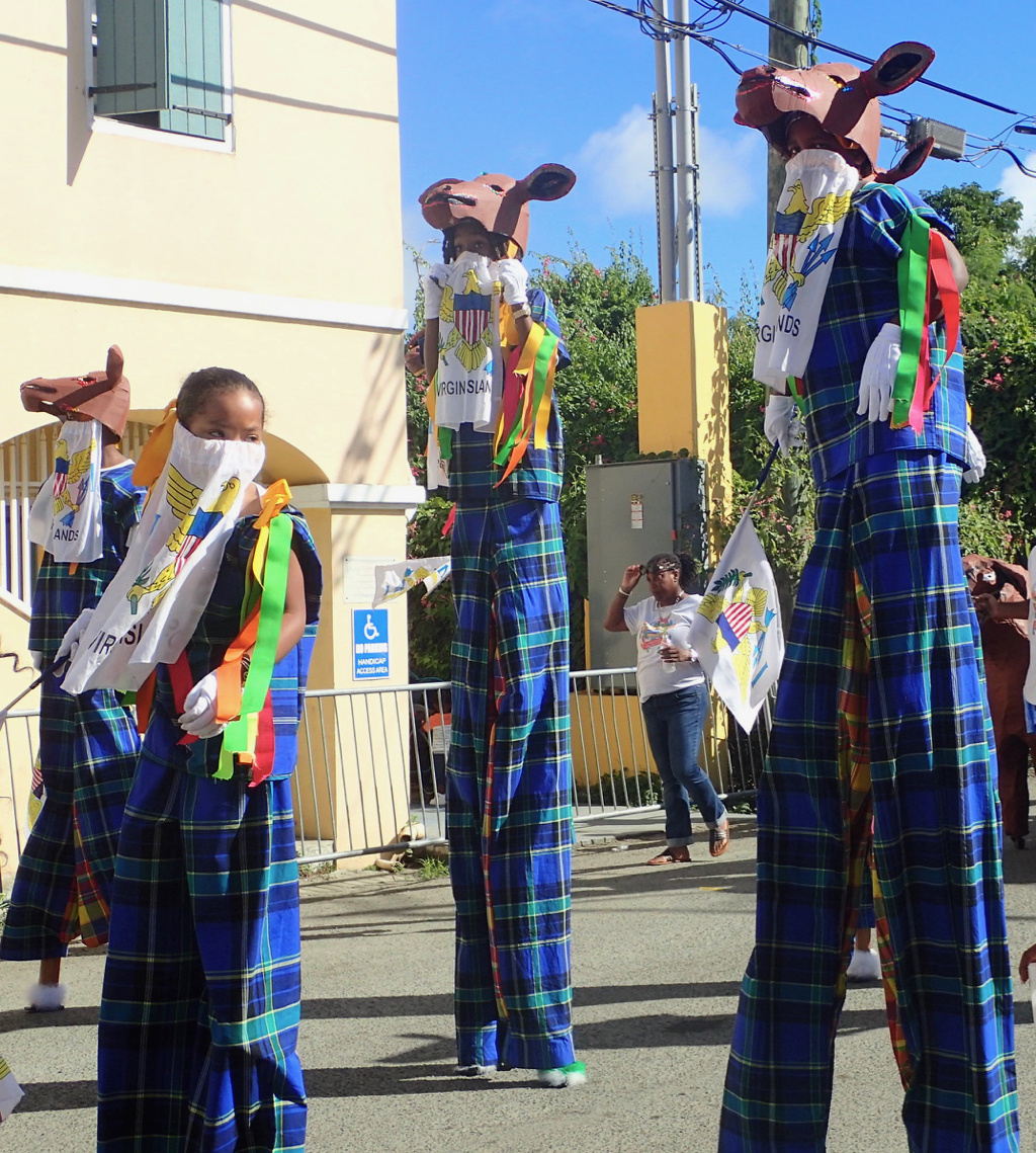Young moko jumbies display the examples of culture with farm animal masks, madras costumes and VI flags. (Susan Ellis photo)