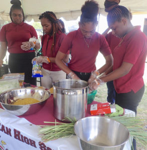 Students from Ivanna Eudora Kean High School present a cooking demonstration Sunday.