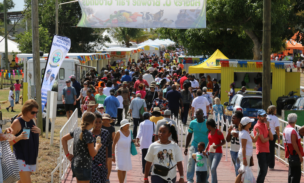 People crowd across the entry bridge to the food booths and other delights as the first day of AgriFest goes into high gear. (Linda Morland photo)