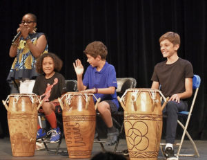 Dara Monifa Cooper asks Antilles students JR Oriol, Jaden Amaro, and Tristan Feddersen to listen to the rhythm of the drums, and work with one another to develop a melody. (Submitted photo)