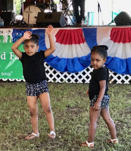 From left, sisters five-year-old Sah'Mya Tapper and three-year-old Mah'Lia Tapper in a reggae mood during Blakness's performance.
