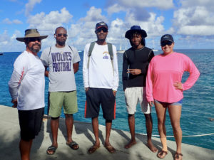 Captain Craig Harms and sailing students Darryl Donohue, Jr., Terrence Nelson Jr., Khalil James and Amaraini Ventura prepare to launch Saturday. (Susan Ellis photo.)