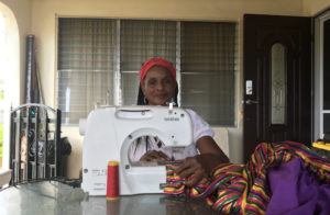 Curliss Solomon-John works at sewing machine, turning out the mocko jumbie costumes. (Elisa McKay photo)