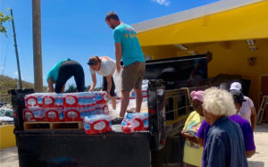 A team of Love City Strong members give out cases of water to St. John residents at the Coral Bay Fire Station.