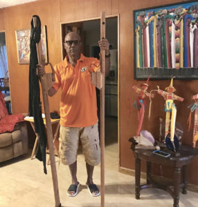 Willard John displays a pair of handmade stilts. (Elisa McKay photo)