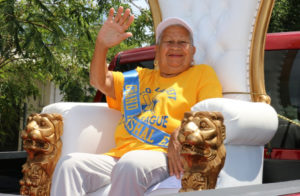 An icon of St. Croix softball, 75-year-old Luz Armstrong waves to the crowd from the opening day parade. (Linda Morland photo)