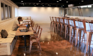 Close to completion, the tasting room will be available for both the general public and for private functions. Director of office operations Shawn Henderson enjoys the ambience as he works. (Linda Morland photo)