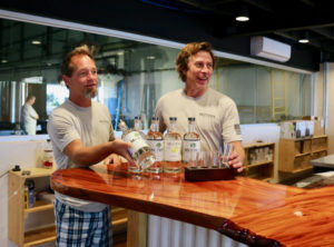 In the tasting room, which offers a clear view of the distillery, Mutiny Island co-founder Todd Manley and director of opeerations and HR Shawn Henderson offer a taste of Mutiny Island Vodka. (Linda Morland photo)
