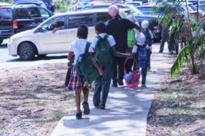 Kids head home from school, skirt for the girl and slacks for the boy.