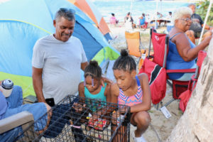 Miguel Rentas enjoys time with granddaughters, Ivelisse Major and Solys Major, as family matriarch Cruz Delgado relaxes behind them. The last week was the first traditional Easter Campign for Ivelisse and Solys. (Linda Morland photo)