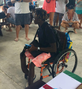 Wheelchair bound Fillemon Waikuwile receives his award.