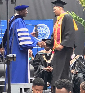 UVI President David Hall, not a short man, congratulates the 6-foot-5 Samuel Liburd Jr at the UVI commencement ceremony. (Photo provided by Dayle Berry)