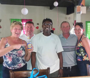 A group of cruise ship visitors surround chef/owner Christopher 'Naddy' Samuel at his Tail End Bar, Restaurant and Courtyard.