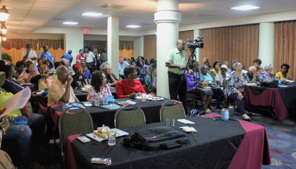 A crowd of 100 attendees listen to presentations give about Airbnb hosting in the territory. (Source photo by Bethaney Lee)