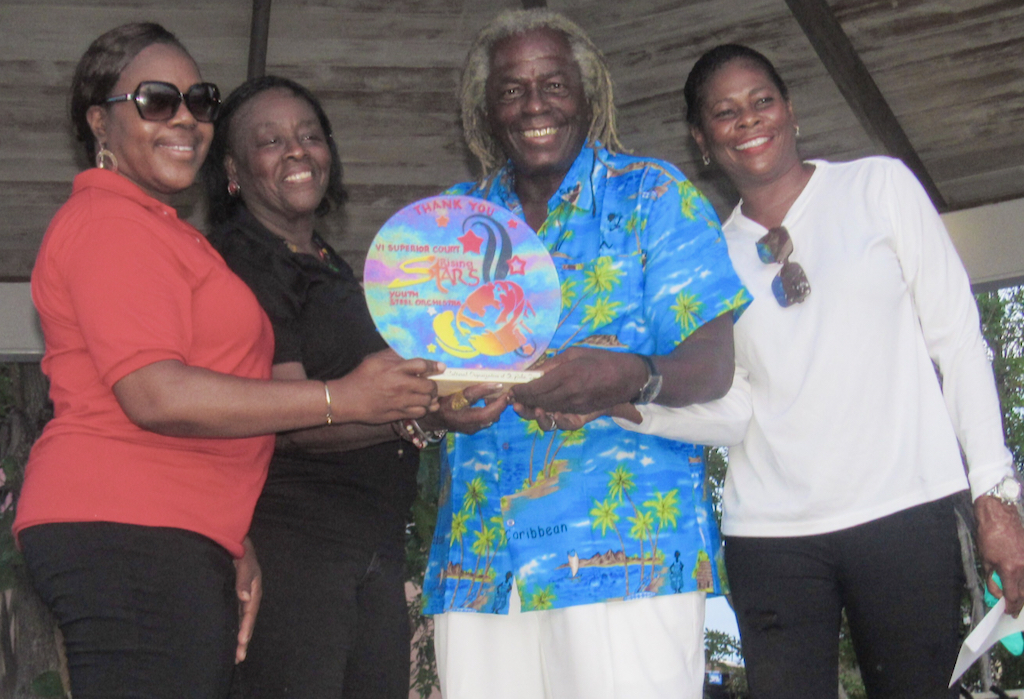 St. Croix Rising Stars Youth Steel Orchestra director Natasha Williams-Modeste presents an appreciation award to St. John Festival Committee members Alecia Wells, Liston “Matey” Sewer, and Leona Smith