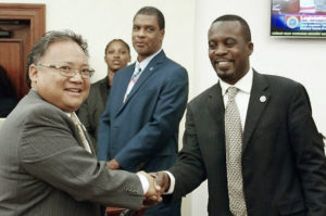 Sen. Marvin Blyden, right, congratulates DLCA Commissioner Richard Evangelista at Tuesday’s session.