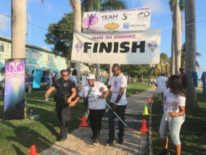 Germaine Powels, who walks with a cane due to her arthritis, triumphantly crosses the finish line. She was the last to finish, earning her the "Caboose Prise," but said she'll be back to take part again. (Elisa McKay photo)