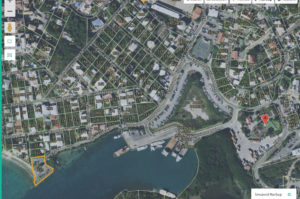 Satellite photo shows the lift station, outlined in orange, lower left, and the wastewater treatment plant marked with red location symbol at the lower right.