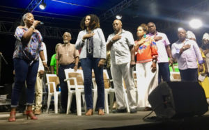 Shikima Jones-Sprauve sings the National Anthem. On-stage dignataries include Delegate to Congress Stacey Plaskett, Gov. Albert Bryan Jr. and Lt. Gov. Tregenza Roach. (Source photo by Amy Roberts)