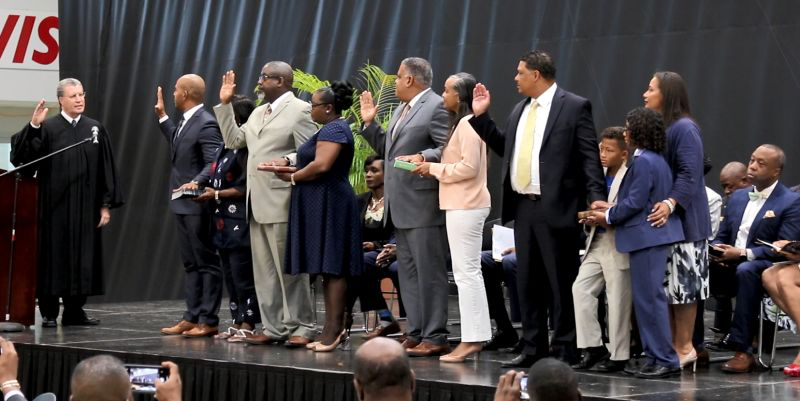 From left: V.I. Supreme Court Chief Justice Rhys S. Hodge administers the oath of office to Nelson Petty Jr., Anthony D. Thomas, Joseph Boschulte, and Jean-Pierre Oriol, surrounded by family. (James Gardner photo)