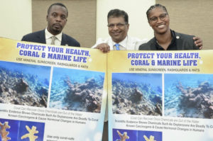 After the sunscreen bill was passed Tuesday by the Senate, Sen. Marvin Blyden, left, environmental advocate Harith Wickrema and Sen. Janelle Sarauw pose with sunscreen bill information. (Photo by Barry Leerdam for the V.I. Legislature)