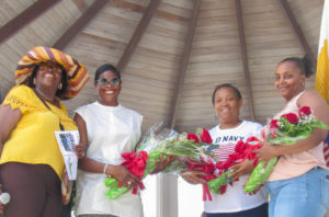 Alecia Wells and Festival Committee members Leona Smith, Enid Doway, and Kela Brathwaite (Source photo by Raven Phillips)