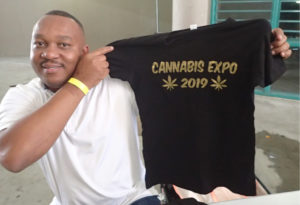 Clayton Thomas displays one of his T-shirts for sale. (Source photo by Susan Ellis)