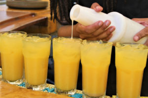 A popular, tropical drink, locally branded as the 'Painkiller,' is mixed for the food tour guests to sample. (Source photo by Bethaney Lee)