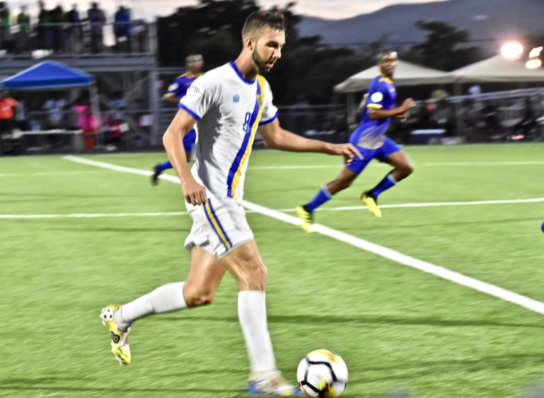 Jett Blaschka of the USVI drives the ball upfield against Barbados Sunday. (Source photo by Wyndi Ambrose)