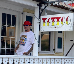 John Turner rests outside his shop, Freedom City Tattoo at 21 Strand Street, Frederiksted. (Source photo by Denise Lenhardt-Benoit)