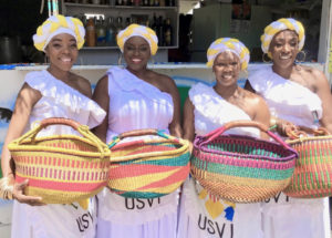 The Caribbean Ritual Dancers posse with their baskets. (Source photo by Amy Roberts)